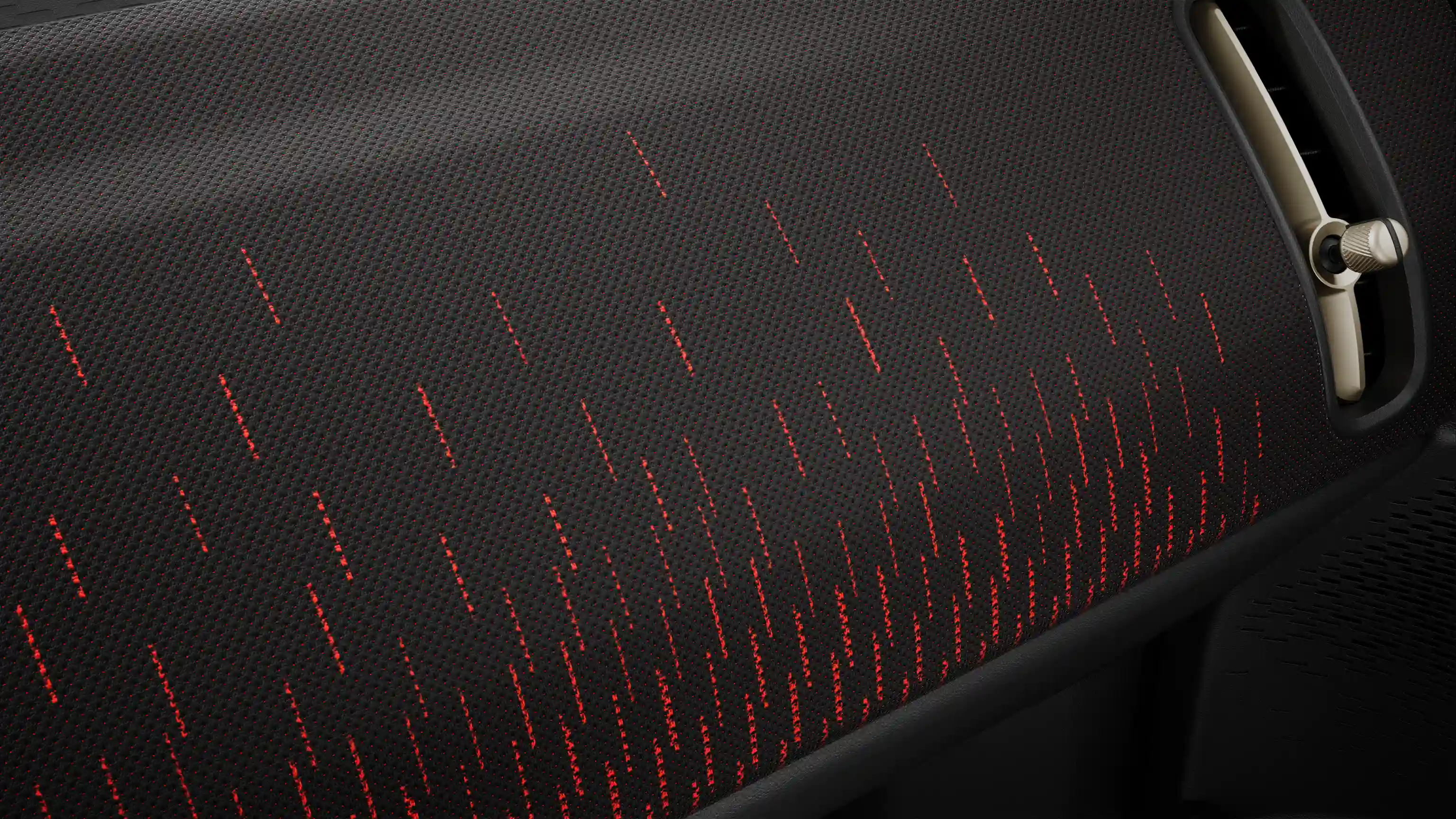 Vista del cruscotto in rosso e nero della MINI Countryman 100% elettrica nella versione JCW