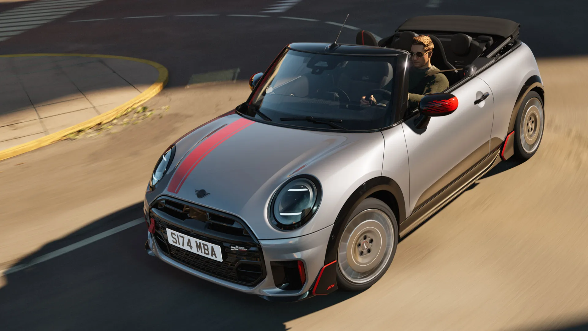 Vista frontale dall'alto della MINI Cabrio con decalcomanie John Cooper Works in Chili Red.